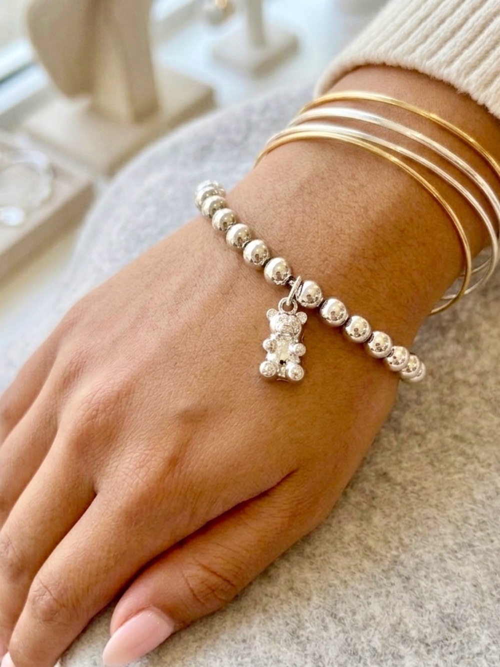 NEW! In box. Gorgeous stretchy beaded bracelet w/ teddy bear charm, silver tone